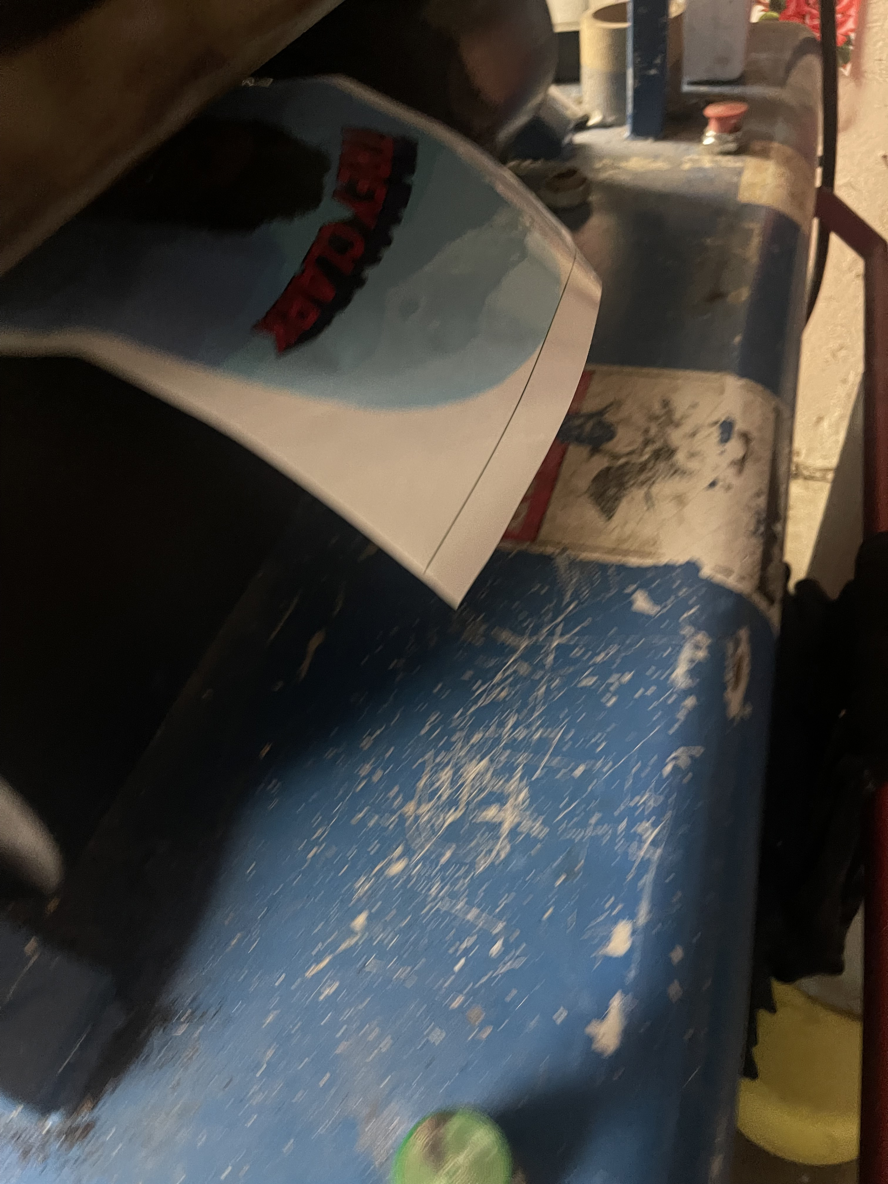 Custom skateboard graphic being applied with heat transfer printing equipment